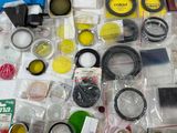 many different types of cameras and lenses on the table