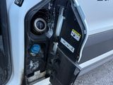 a white van with a gas pump attached to the side of it