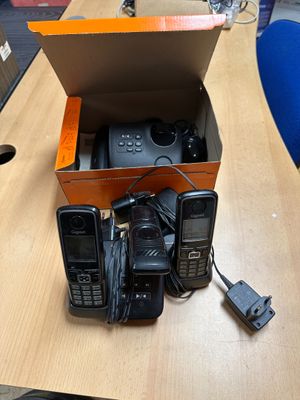 three cell phones in a box on a table