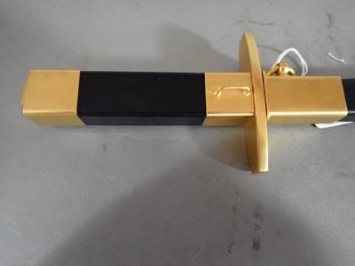 a gold and black sword with a black handle