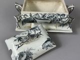 two black and white dishes with a bird design on them