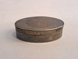 a small metal box sitting on a white surface