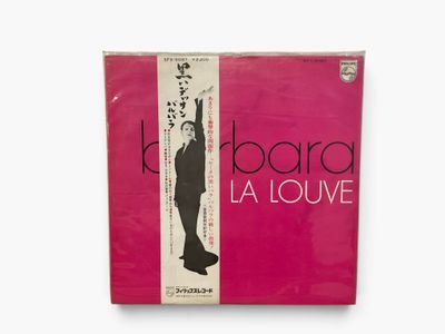 a pink album cover with an image of a woman in a long dress