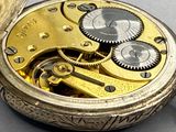 a close up of a pocket watch with gears on it