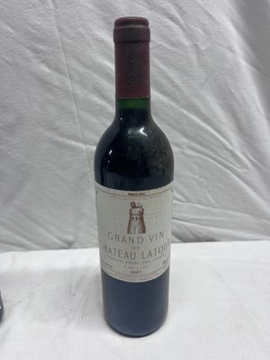 a bottle of wine sitting on a table next to a bottle of wine