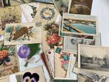 a pile of old postcards on a table