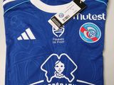 a blue soccer jersey with a white and blue logo on it