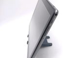 a tablet computer sitting on a stand on a white surface