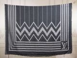 a black and white blanket hanging on a wall in a room