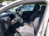 the interior of a car with the door open and the driver ' s seat down
