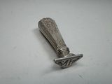 an antique silverware spoon with a decorative design on it