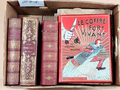 many books in a box that are sitting on a table