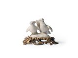 figurine of two penguins on a tree stump with a white background
