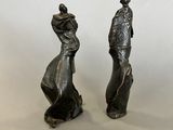 pair of antique bronze figurines of a woman and a man