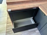 a wooden counter top with a drawer in it