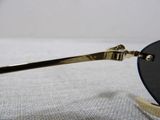 gold metal frame sunglasses with black lens on a white cloth