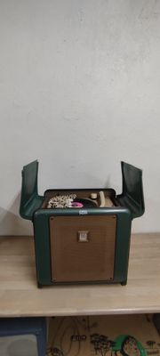 une boîte verte posée sur une table en bois