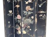 an image of a black room divider with flowers and birds on it