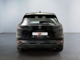the rear end of a black car in a white room