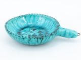 blue ceramic bowl with a turtle shaped handle on a white background