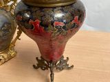 two vases sitting on a table next to each other