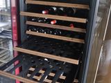 a wine cooler that has many bottles of wine in it