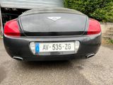 a black sports car parked in front of a garage