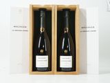 deux bouteilles de vin dans un coffret en bois sur une surface blanche