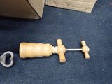 a small wooden object with a wooden handle on the floor