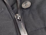 a close up of a zipper on a jacket with a button on it