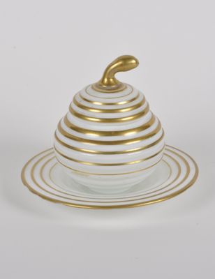 an image of a white and gold plate topped with a bowl