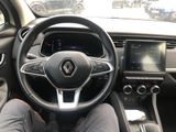the steering wheel of a car with a person sitting in the driver ' s seat