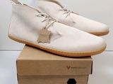 the white shoe is sitting on top of a cardboard box