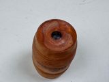 a small wooden object on a white surface