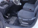 the interior of a small white car with black seats and a steering wheel