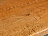 a close up of a wooden table with writing on it