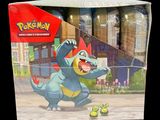 a box of pokemon toys with a picture of a blue dragon