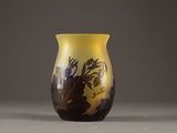 a yellow vase with a design on it on a table