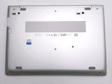 the back of a silver laptop with a blue sticker on the bottom of it