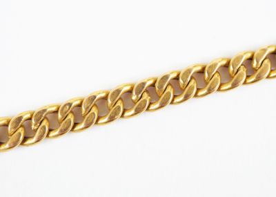 a close up of a gold chain on a white background