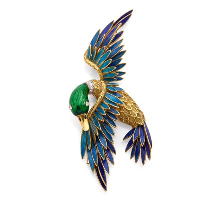 a close up of a bird brooch on a white background