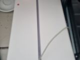 a white box sitting on top of a table next to a laptop