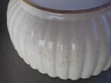 a close up of a white vase on a table