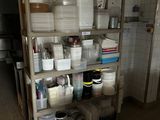 a shelf full of dishes and containers in a kitchen