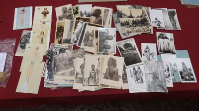 a red table with many old photos on it