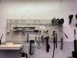 a picture of a workbench with tools hanging on it