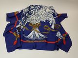 an image of a blue and white scarf with a bird on it