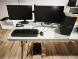 two computer monitors and a keyboard on a desk