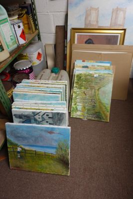 many paintings on the shelves in the room