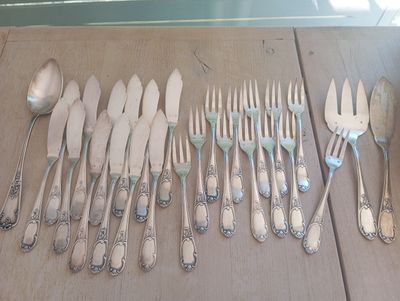 a lot of spoons and forks laid out on a table